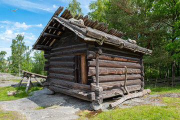 Wooden, vintage log shed in the countryside.