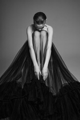 Beautiful woman pose in studio. Art portrait of a model in a black dress - 510603701