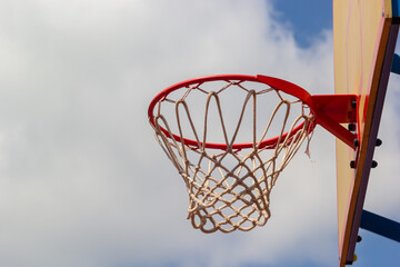 Photo of glass basketball hoop and blue sky background,basketball basket