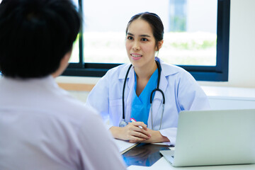 Portrait Asian woman doctor and asian man patient. Smiling female doctor talking consulting with patient. Hospital Healthcare and medicine concept.