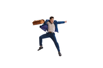 Portrait of young man. office worker in official suit, jumping over with suitcase isolated over white studio background