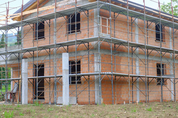 construction site with equipment and building. House in construction close-up. Building construction site. Construction works	
