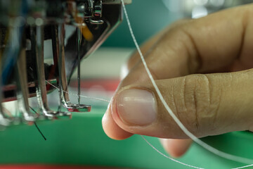 Closeup on Embroidery machine needle in Textile Industry at Garment Manufacturers, Embroidery...