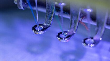Closeup on Embroidery machine needle in Textile Industry at Garment Manufacturers, Embroidery needle, Needle with thread (selective focus and soft focus)