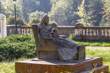 Metal statue of grandmother in palace garden