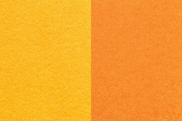 Texture of craft yellow and orange paper background, half two colors, macro. Structure of vintage cardboard.