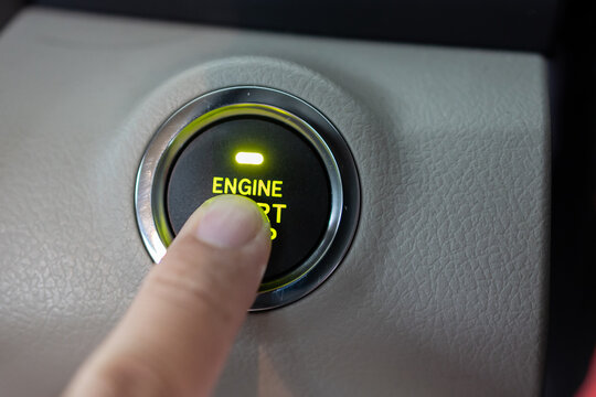 Man finger on pushing a start ignition button switch in the modern luxury car