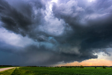 Storm clouds over field, tornadic supercell, extreme weather, dangerous storm