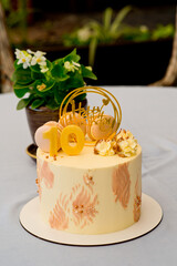 A beautiful cake decorated with cream, the number ten and congratulations on your birthday.