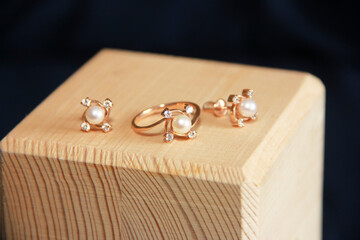women's gold jewelry, earrings and a ring with white pearls