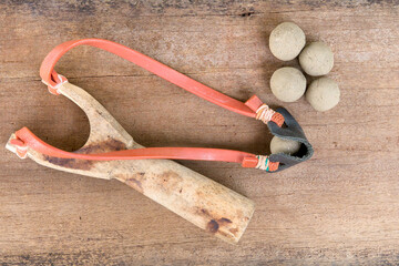 Catapult And Soil Bullets On The Wooden Table