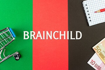 BRAINCHILD - word (text) and euro money on a table of different colors, a trolley, a basket of grocery notepad and a red pencil. Business concept, buying, selling, supermarket, store (copy space).