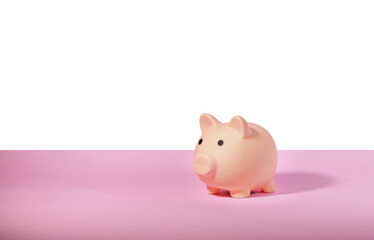 Piggy bank isolated on pink background. Saving money concept.