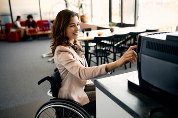 Happy businesswoman with disability using coffee machine in office.