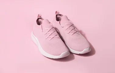 Gordijnen Pink pastel color sneakers on background © alimyakubov