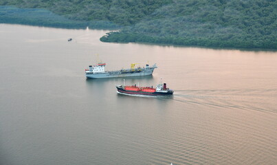 View from the top of a cargo ship rushing into the harbor. The opposite of the oil tanker sprinting towards the sea.
