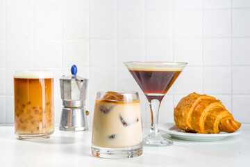 Set of three coffee drinks in various cocktails glasses, on white background copy space