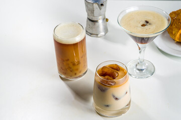 Set of three coffee drinks in various cocktails glasses, on white background copy space