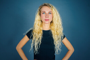 Young blonde woman looks confident on studio