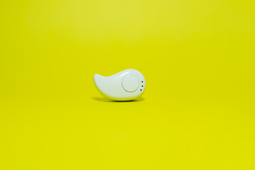 bluethoot earphones or hands-free earphones isolated on yellow background
