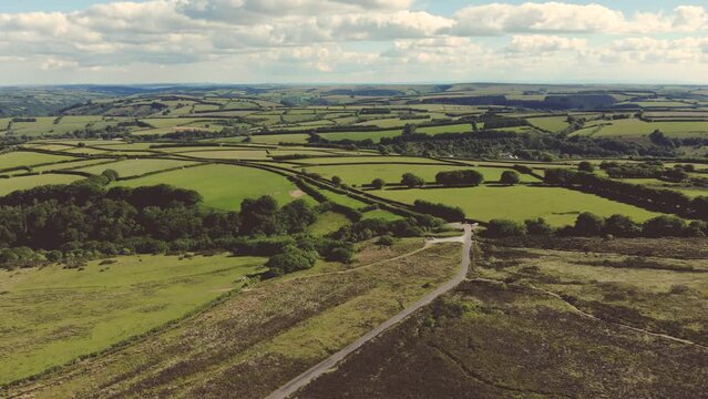 Aerial drone shot of lush green countryside and moorland in Exmoor National Park, UK