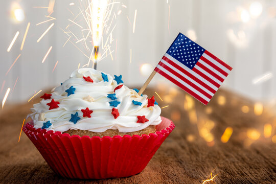 a cupcake with a flag and sparkler