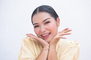 Exciting woman pointing at teeth braces or orthodontics dental braces, cosmetic dental care concept