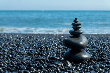 Balanced stones on Reynisfjara black beach in Iceland