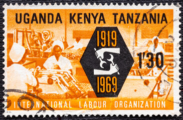 KENYA UGANDA TANZANIA - CIRCA 1969: A stamp printed in Kenya Uganda Tanzania shows Industry and ILO...