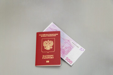 Russian foreign passport and 500 euro cash on gray background. Travel abroad