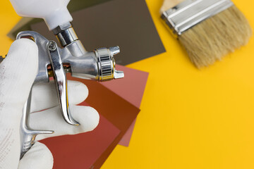 paint spray gun at work at the workplace in the workshop.