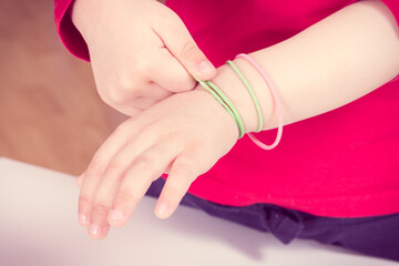 Little boy putting rubber bands or erasers on hand. Best creative game for early fine motor skills and logical thinking