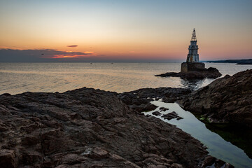Fototapeta premium Cloudy sunrise near the lighthouse of Ahtopol, Black Sea, Bulgaria