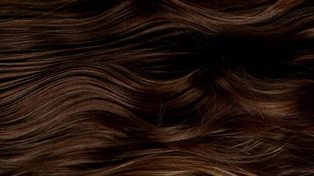 Super slow motion of wavy brown hair in detail. Filmed on high speed cinema camera, 1000 fps.