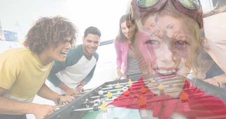 Multiple image of multiracial friends playing foosball and cute caucasian boy wearing cape, glasses