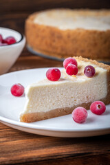 Cheesecake slice. Classical New York cheese cake on wooden background