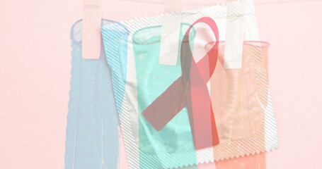 Double exposure image of red ribbon and condoms, copy space