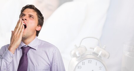 Digital composite image of tired caucasian young businessman with alarm clock, copy space - Powered by Adobe