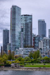 Fototapeta na wymiar Residential Home Buildings in Downtown Vancouver, British Columbia, Canada. False Creek. Cloudy Sky Background
