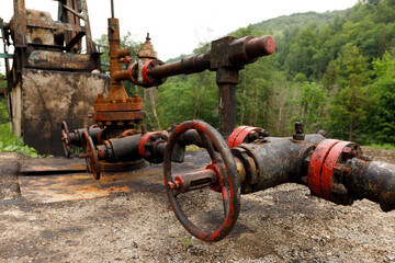 Old rusty crane for supplying oil.