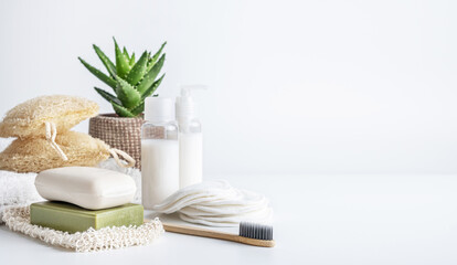 Zero waste, sustainable bathroom beauty products. Bamboo toothbrush, oganic soap bar, loofah sponge, cotton pads