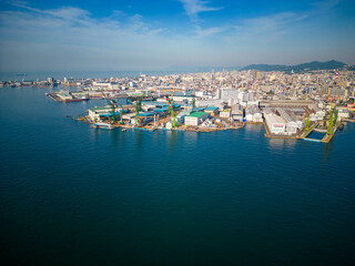 Fototapeta na wymiar Aerial view of dormant cargo cranes at empty shipping port