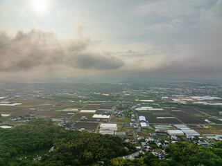 Morning clouds and mist over rural community 