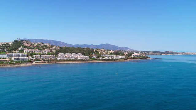 Coastline of Mijas Costa real estate, drone moving forward