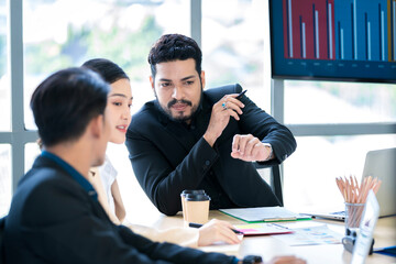 Bearded Asian businessman doing business at company office