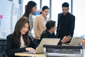 Asian businessman Working and meeting at the office at the company with colleagues at the back