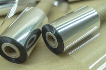 Thermal transfer ribbon - TTR. Wax thermo ribbon on cardboard reel for barcode. Supply material for printing industry. Selective focus