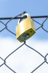 Padlock and its lock on the river bridge