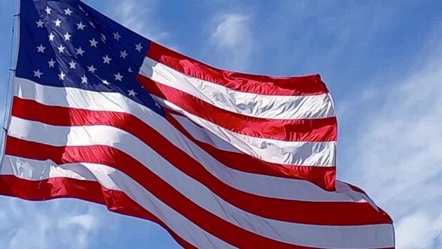 American flag blowing in the wind. brightly lite by the sun 