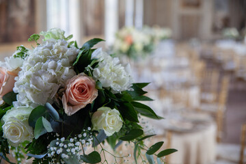 hall of an ancient castle with catering for catering and wedding events. Detail of floral bouquet on table